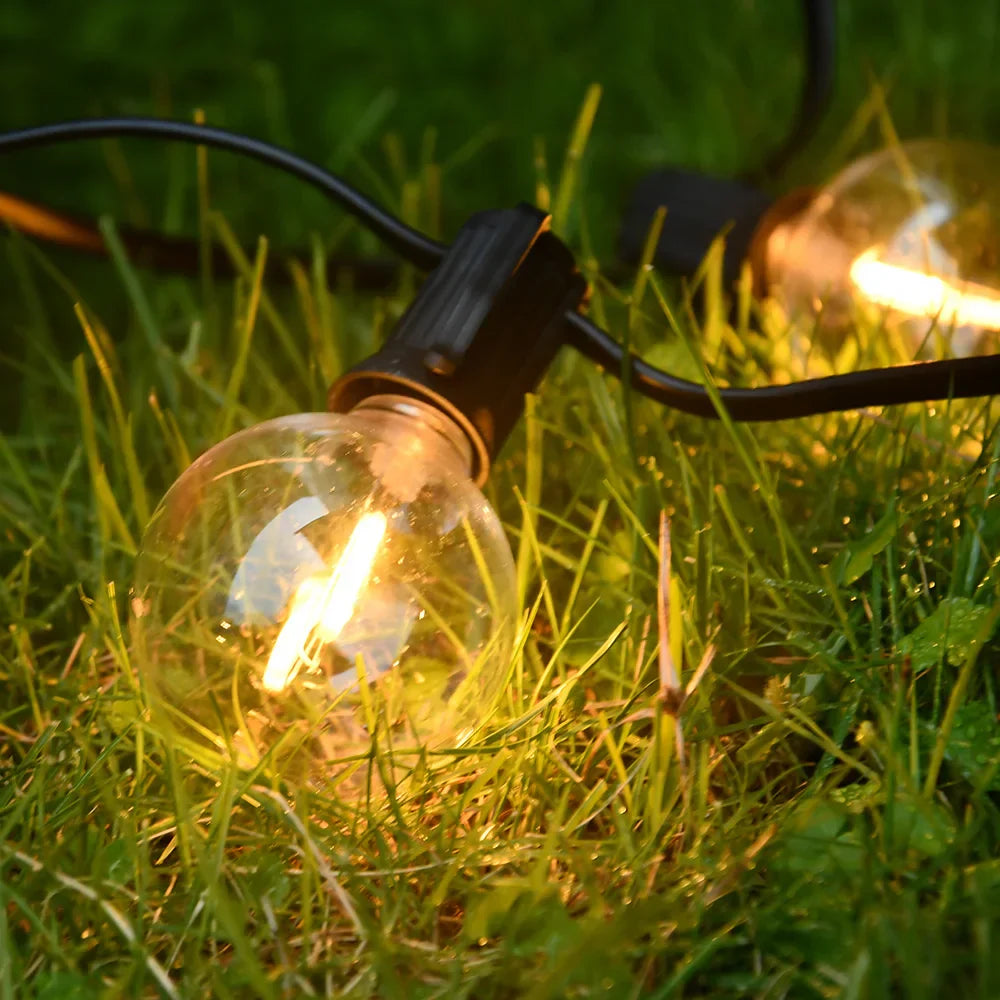 Udendørs LED-lyskæde med varmt hvidt lys hængt op på terrasse